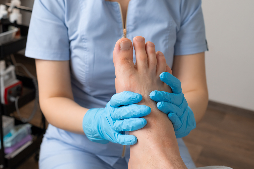 Close up a man undergoes a foot massage session by a professional masseur at the clinic. close up a man undergoes a foot massage session by 2026 03 23 23 04 10 utc